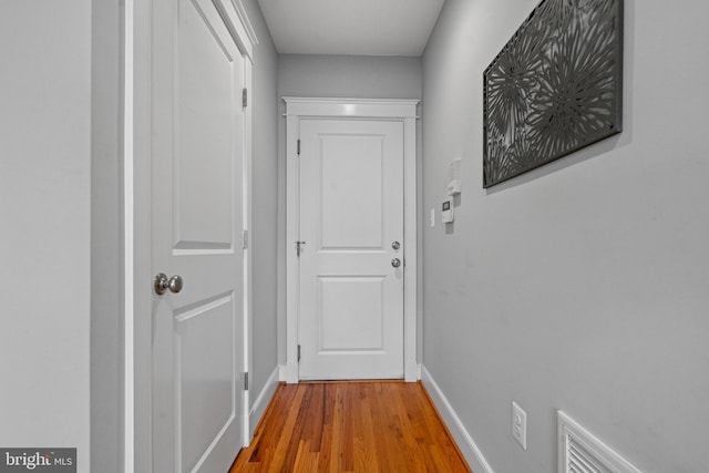 hallway with hardwood / wood-style floors