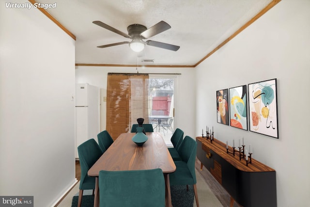 dining room featuring ceiling fan and ornamental molding