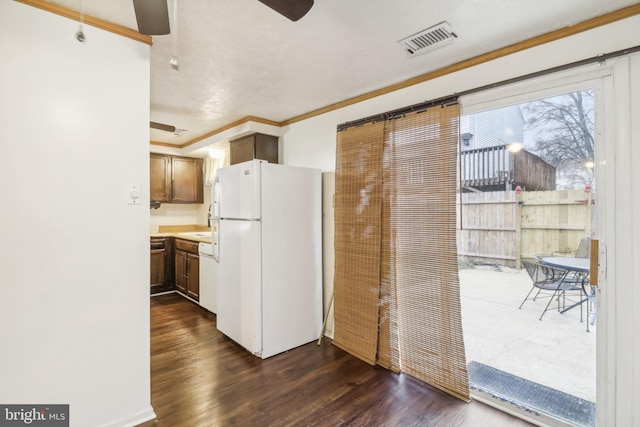 kitchen featuring dark hardwood / wood-style flooring, white appliances, and crown molding