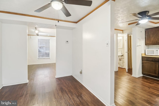 unfurnished room with ceiling fan, dark hardwood / wood-style flooring, and crown molding