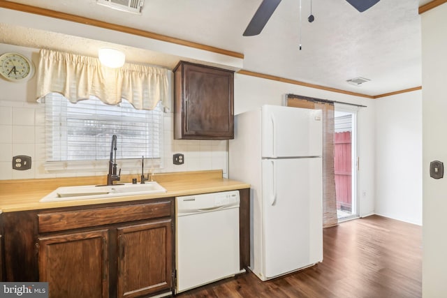 kitchen featuring ceiling fan, sink, dark wood-type flooring, crown molding, and white appliances