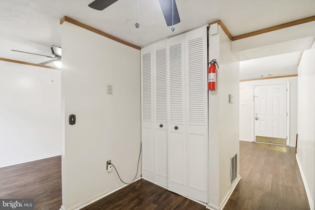 hallway featuring dark wood-type flooring and ornamental molding