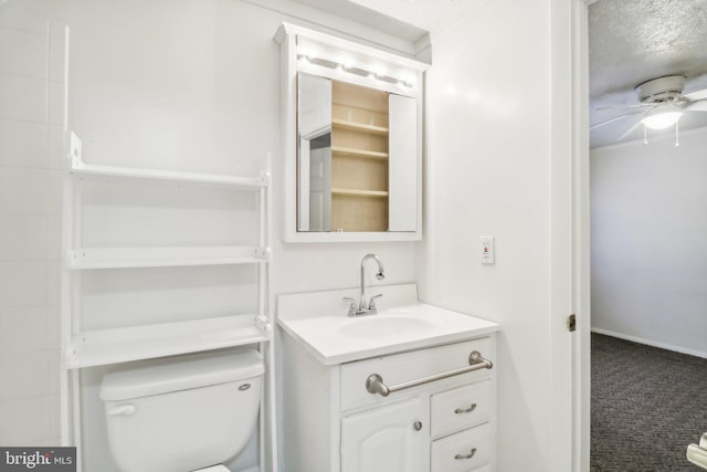 bathroom with ceiling fan, toilet, and vanity