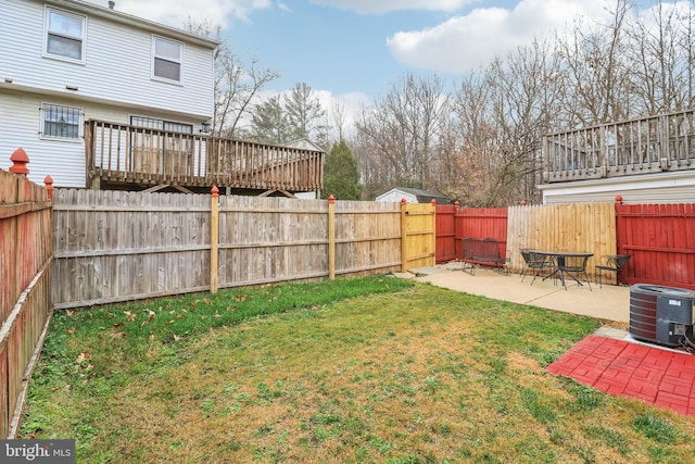 view of yard with a deck, a patio, and central AC