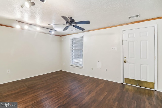 foyer with dark hardwood / wood-style floors, ceiling fan, and a textured ceiling