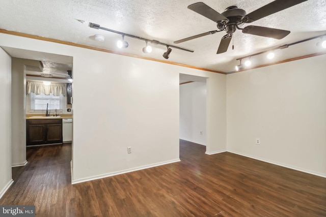 unfurnished room featuring dark hardwood / wood-style flooring, ornamental molding, a textured ceiling, ceiling fan, and sink