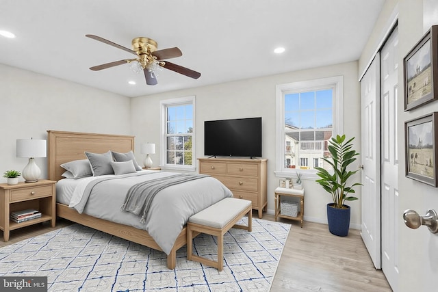 bedroom with ceiling fan and light wood-type flooring