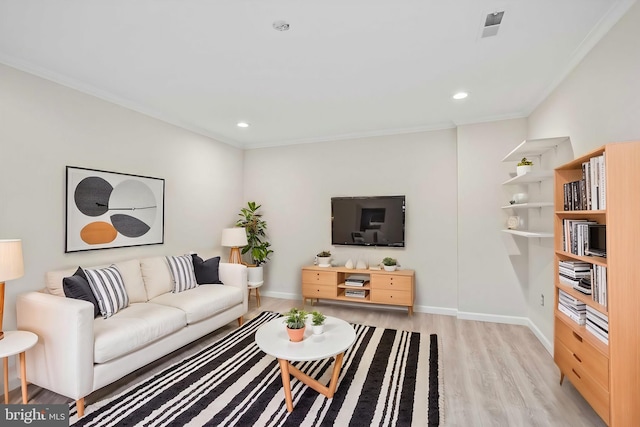 living room featuring crown molding and light hardwood / wood-style flooring