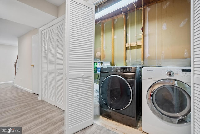 washroom featuring separate washer and dryer and light hardwood / wood-style flooring