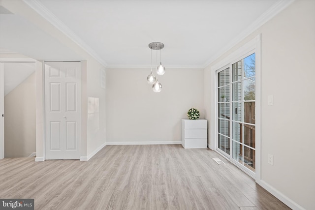 unfurnished dining area featuring crown molding and light wood-type flooring