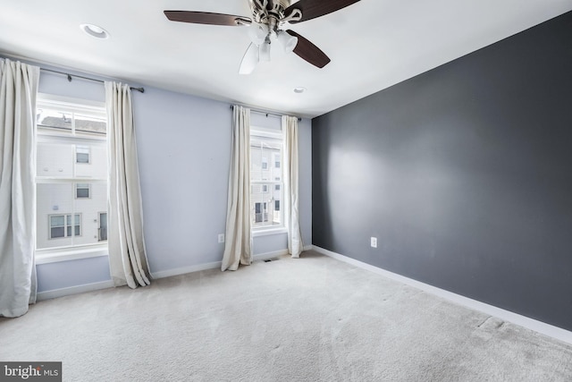 empty room featuring light carpet and ceiling fan