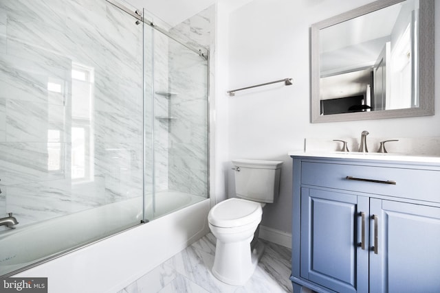 full bathroom featuring vanity, combined bath / shower with glass door, and toilet