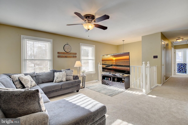 carpeted living room featuring ceiling fan and plenty of natural light