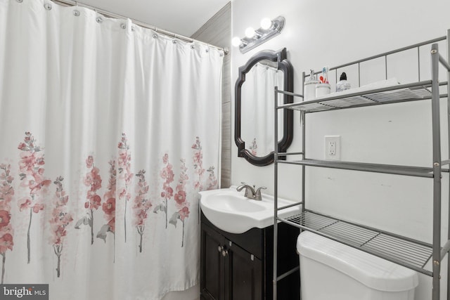 bathroom featuring toilet and vanity