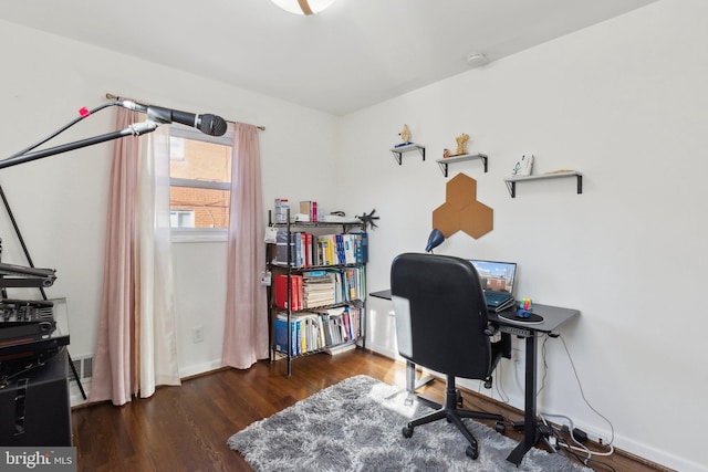 home office with dark hardwood / wood-style flooring