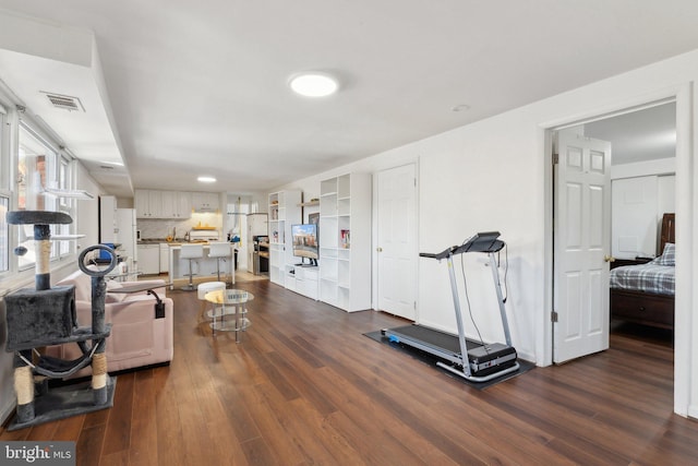 workout room with dark wood-type flooring