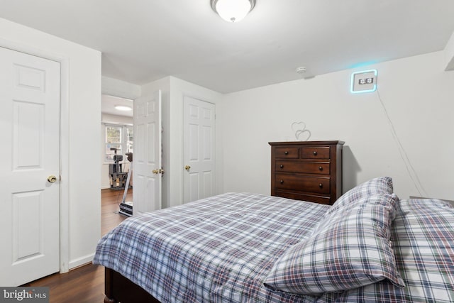 bedroom with dark wood-type flooring