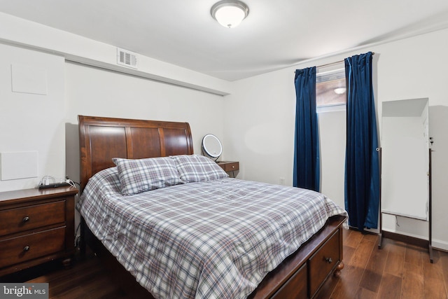 bedroom with dark hardwood / wood-style floors