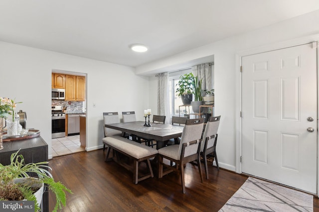 dining space featuring dark hardwood / wood-style floors