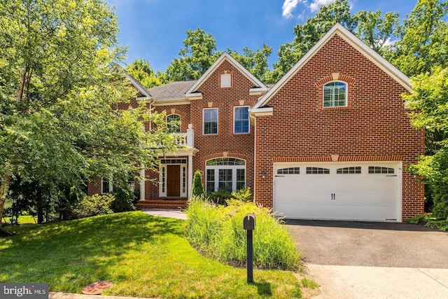 front facade featuring a garage and a front yard