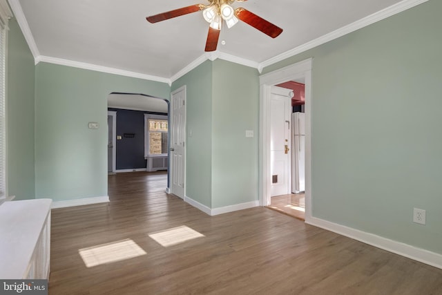 spare room with dark hardwood / wood-style flooring, ceiling fan, and ornamental molding