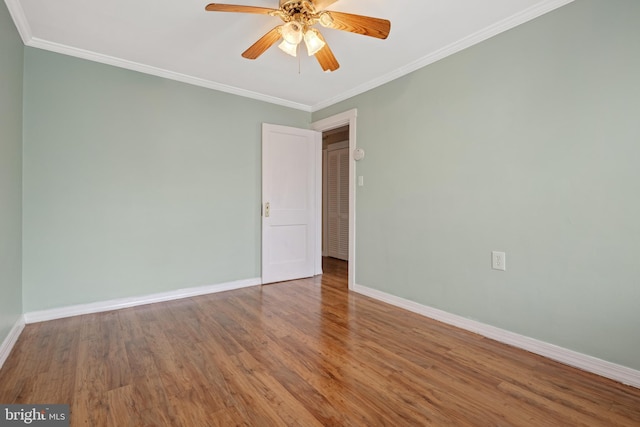 spare room with wood-type flooring, ceiling fan, and ornamental molding