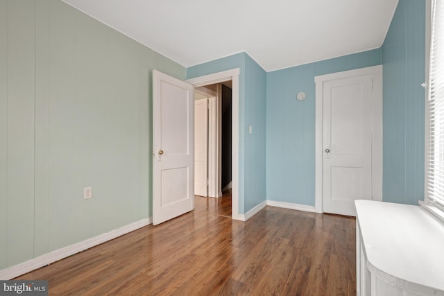 unfurnished bedroom with dark wood-type flooring