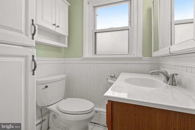 bathroom with tile patterned floors, vanity, and toilet