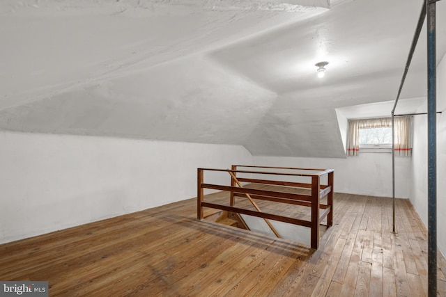 bonus room featuring wood-type flooring and lofted ceiling