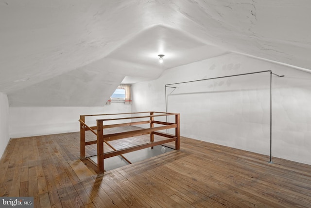 bonus room with hardwood / wood-style floors and lofted ceiling