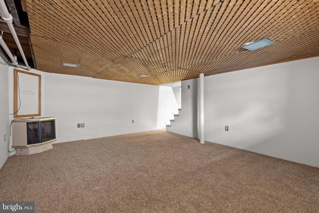 basement featuring carpet and wooden ceiling