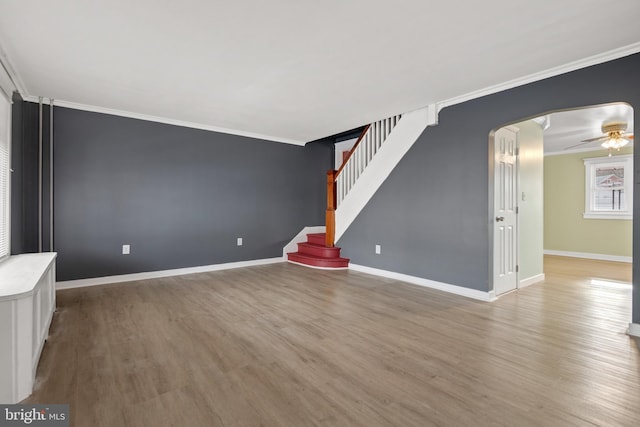 unfurnished living room with crown molding, ceiling fan, and light hardwood / wood-style floors