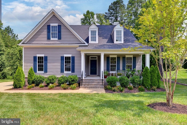 cape cod-style house with covered porch and a front lawn