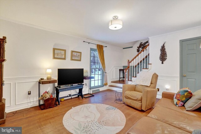 living room featuring ornamental molding and hardwood / wood-style floors