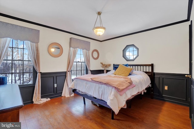 bedroom featuring ornamental molding and hardwood / wood-style floors