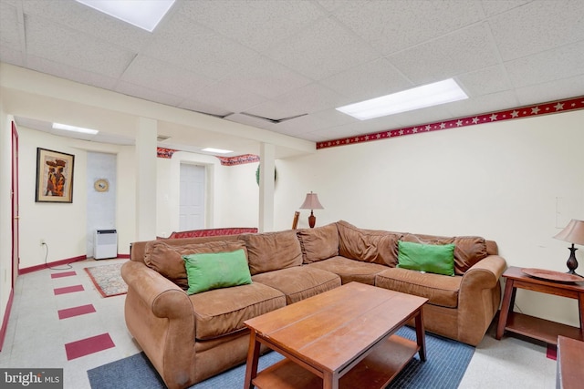 living room with a paneled ceiling