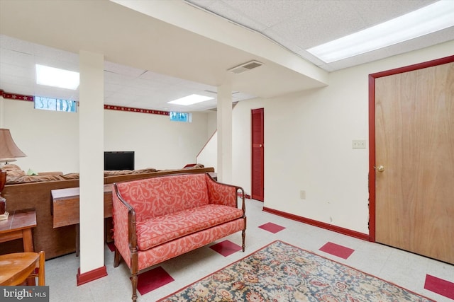 living room with a drop ceiling