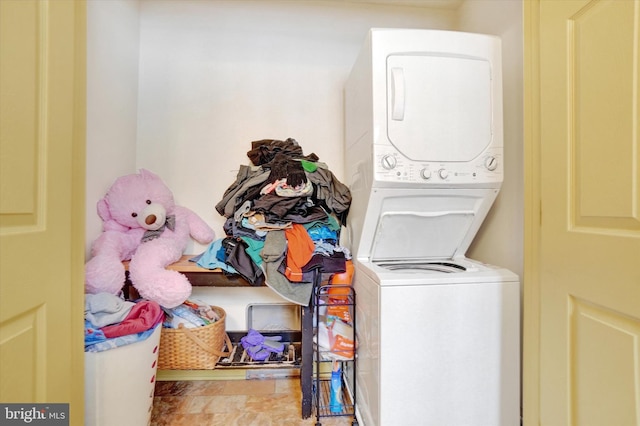 clothes washing area with stacked washer and dryer