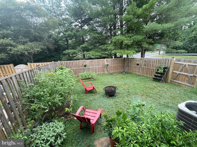 view of yard featuring an outdoor fire pit and cooling unit