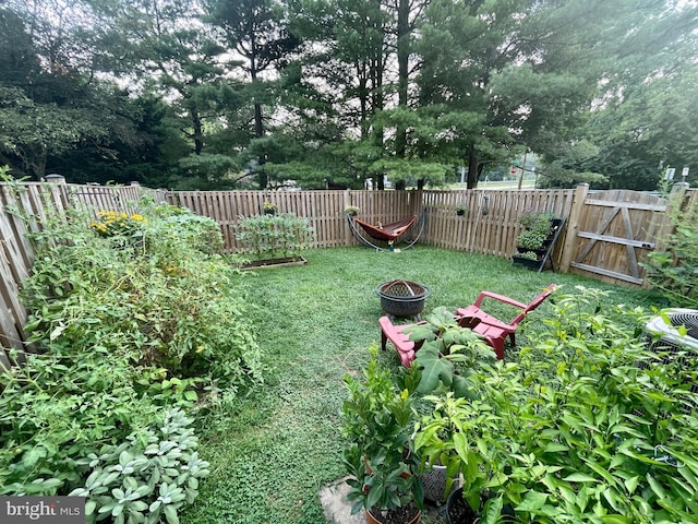 view of yard with an outdoor fire pit