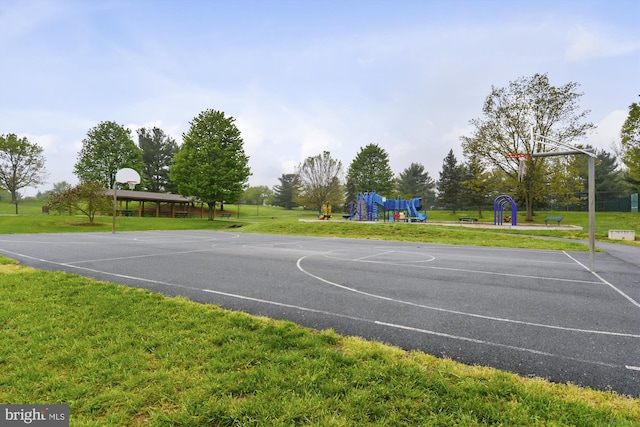 view of sport court featuring a yard and a playground