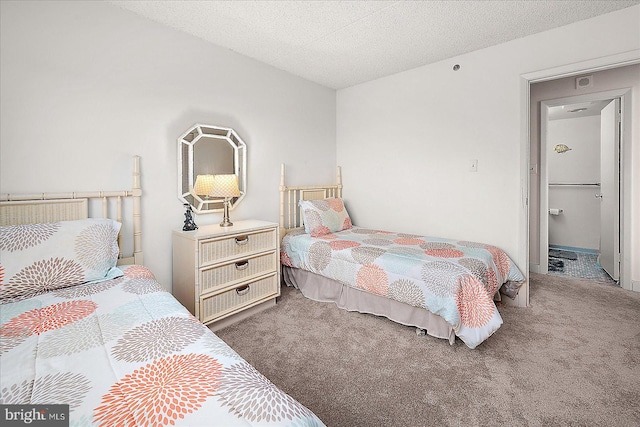 bedroom with carpet and a textured ceiling