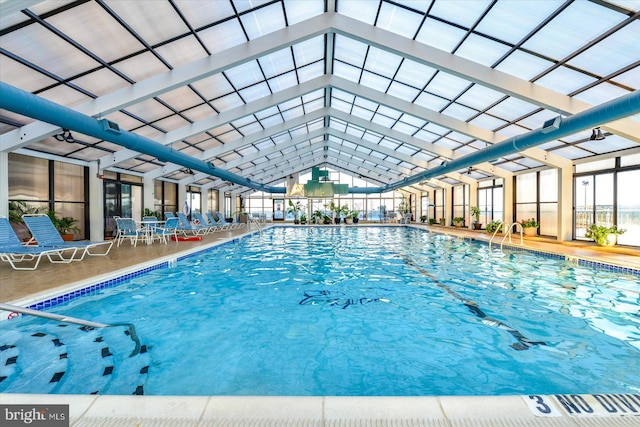 view of swimming pool featuring a lanai