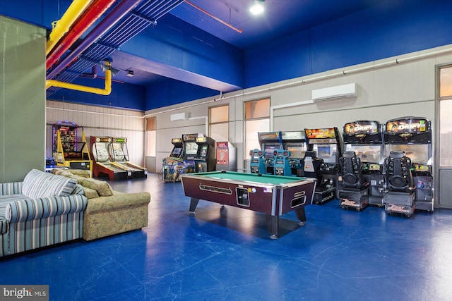 playroom with a towering ceiling, pool table, and a wall mounted air conditioner