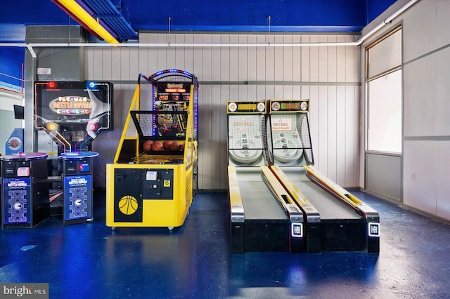 game room with wood walls