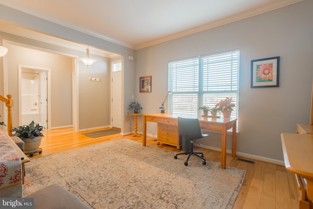 home office featuring ornamental molding and light wood-type flooring