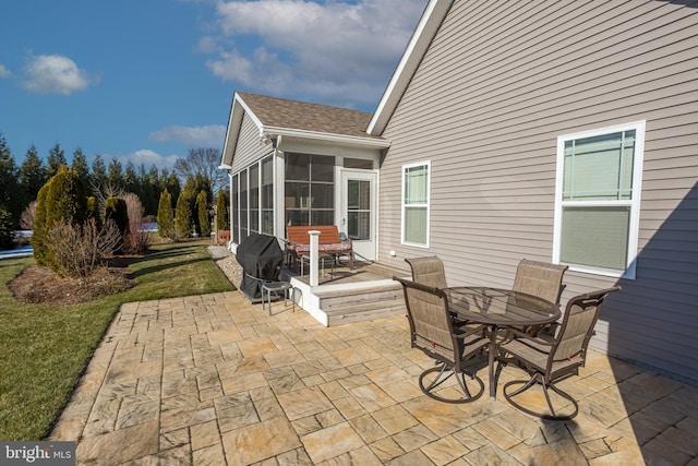 view of patio featuring area for grilling and a sunroom