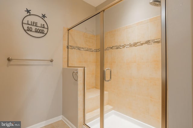 bathroom with a shower with door