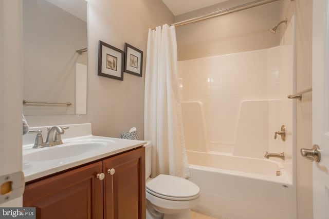 full bathroom with vanity, shower / tub combo, and toilet