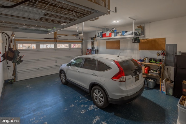 garage with a garage door opener and electric panel